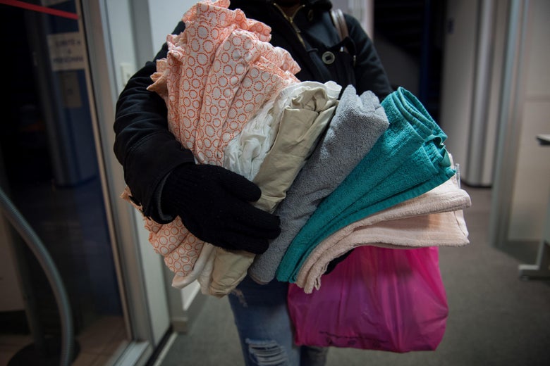 A man holds blankets inside a hosting center of December 18, 2017 in Orleans, central France.